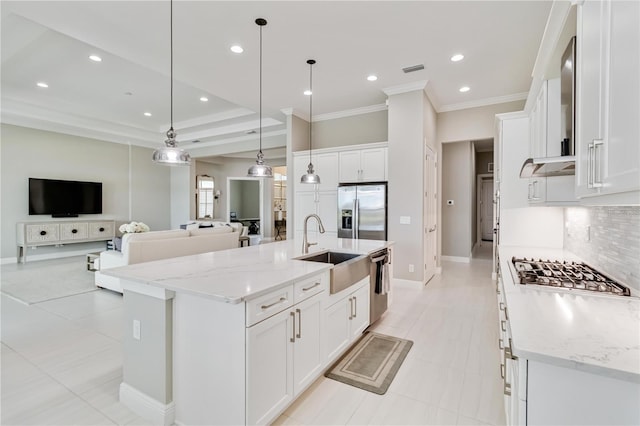 kitchen with crown molding, backsplash, a sink, white cabinetry, and stainless steel appliances