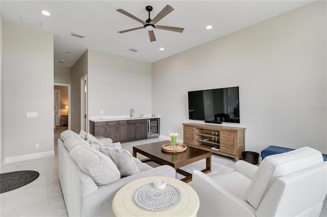 living area featuring baseboards, wine cooler, recessed lighting, and a ceiling fan