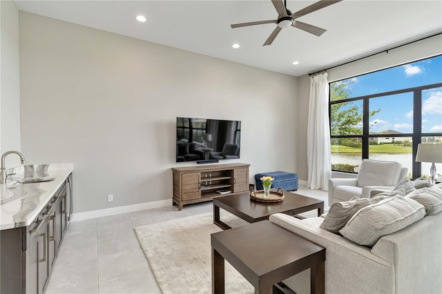 living room featuring baseboards, light tile patterned flooring, recessed lighting, and a ceiling fan