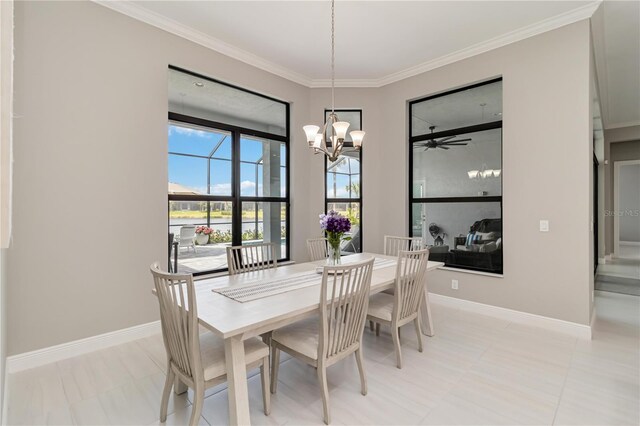 dining area featuring baseboards, crown molding, and ceiling fan with notable chandelier
