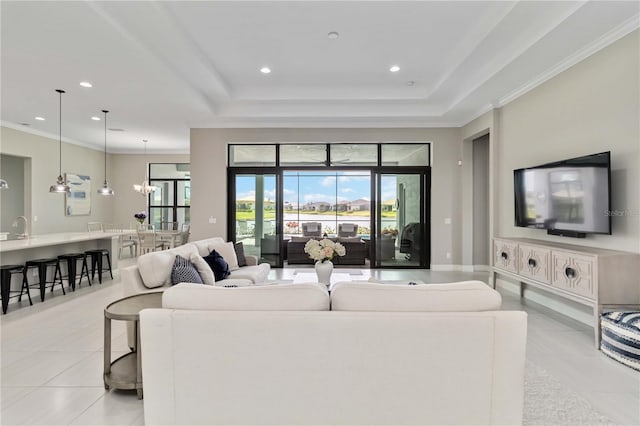 living room featuring light tile patterned flooring, crown molding, recessed lighting, and a raised ceiling