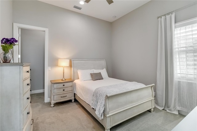bedroom featuring ceiling fan, light colored carpet, and visible vents