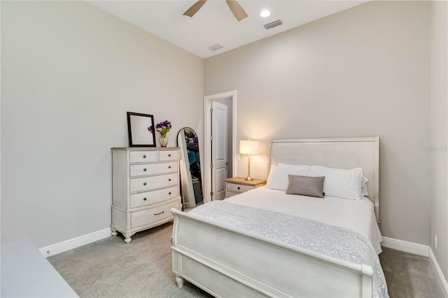 carpeted bedroom featuring baseboards, visible vents, and a ceiling fan