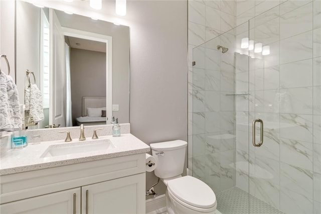 bathroom with a shower stall, toilet, and vanity