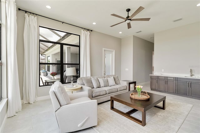 living room featuring visible vents, baseboards, ceiling fan, recessed lighting, and light tile patterned floors
