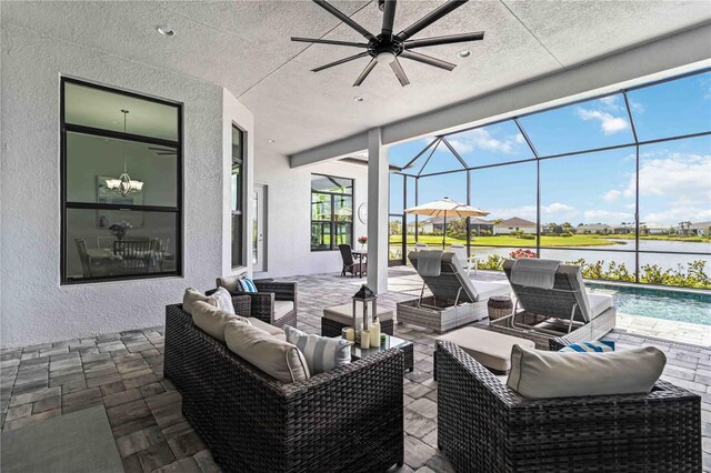 view of patio featuring an outdoor living space, a water view, ceiling fan, and a lanai