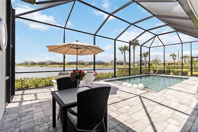 outdoor pool featuring a water view, a lanai, and a patio area
