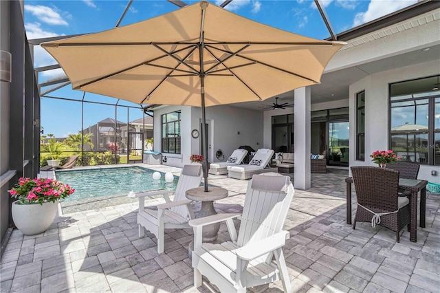 pool with a patio, an outdoor hangout area, ceiling fan, and a lanai