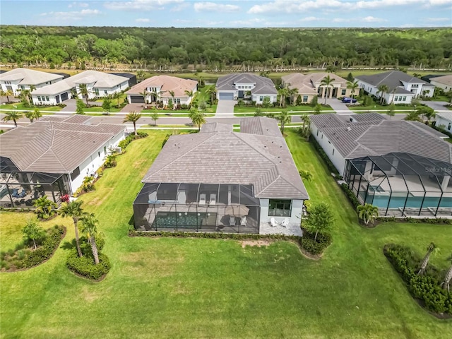 drone / aerial view with a view of trees and a residential view