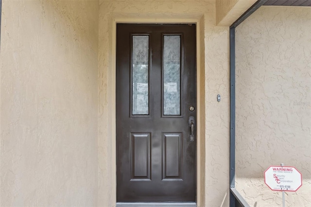 2192 Hyatt Dr, Port Charlotte, FL 33948 - doorway to property with stucco siding