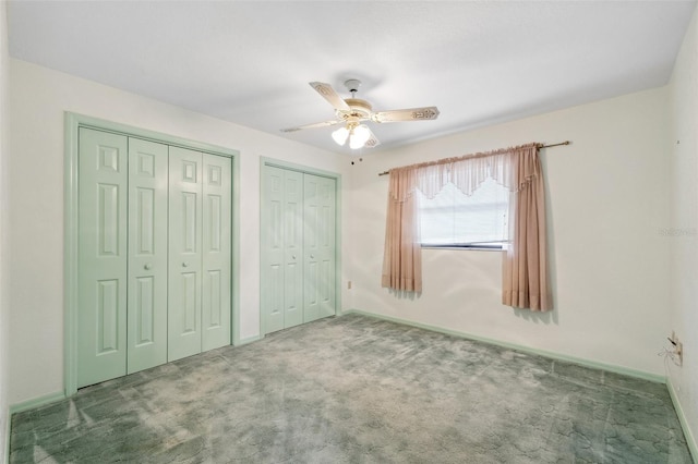2192 Hyatt Dr, Port Charlotte, FL 33948 - unfurnished bedroom with carpet floors, ceiling fan, baseboards, and multiple closets