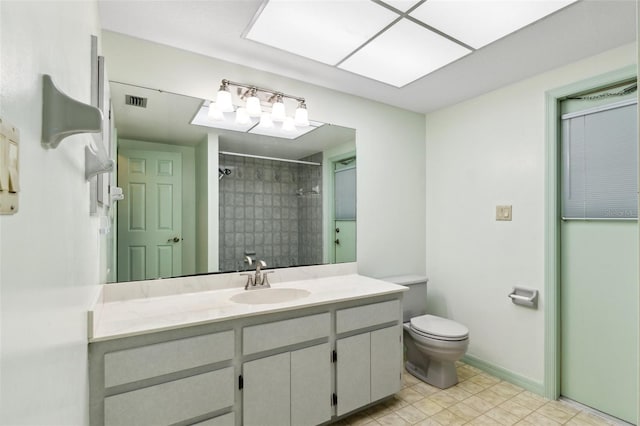 2192 Hyatt Dr, Port Charlotte, FL 33948 - bathroom with vanity, baseboards, toilet, visible vents, and a tile shower