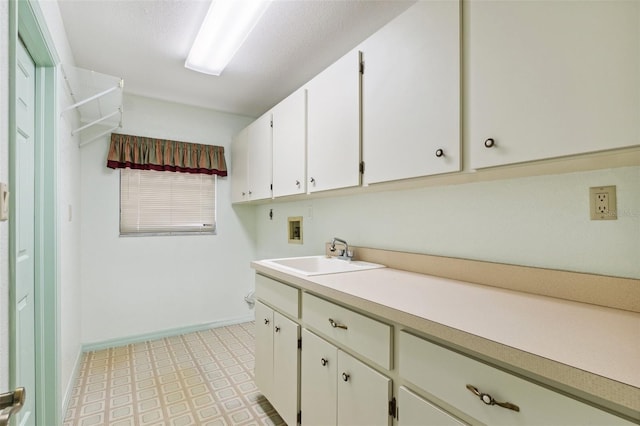2192 Hyatt Dr, Port Charlotte, FL 33948 - laundry room featuring baseboards, washer hookup, cabinet space, light floors, and a sink