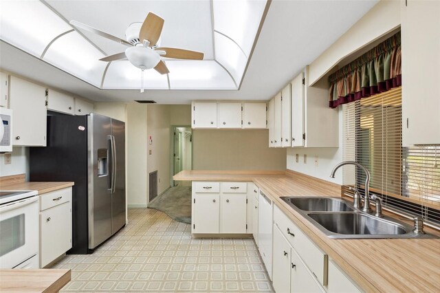 2192 Hyatt Dr, Port Charlotte, FL 33948 - kitchen with a sink, light countertops, ceiling fan, white appliances, and a peninsula