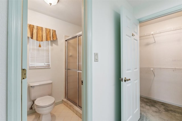 2192 Hyatt Dr, Port Charlotte, FL 33948 - bathroom with a spacious closet, toilet, a stall shower, and baseboards