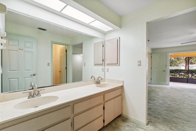2192 Hyatt Dr, Port Charlotte, FL 33948 - bathroom with double vanity, visible vents, baseboards, and a sink