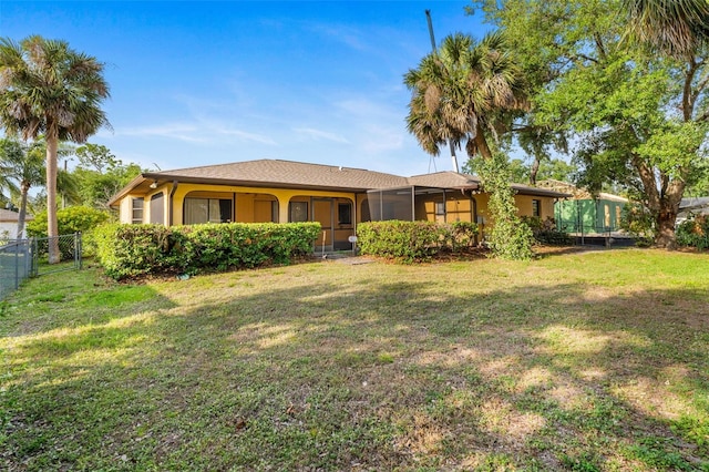 2192 Hyatt Dr, Port Charlotte, FL 33948 - view of front facade featuring a front lawn, fence, and stucco siding