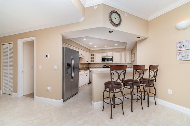 1326 Wesley Dr Unit 123, Punta Gorda, FL 33950 - kitchen featuring a peninsula, glass insert cabinets, backsplash, crown molding, and stainless steel appliances