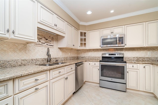 1326 Wesley Dr Unit 123, Punta Gorda, FL 33950 - kitchen featuring light stone counters, a sink, ornamental molding, and stainless steel appliances