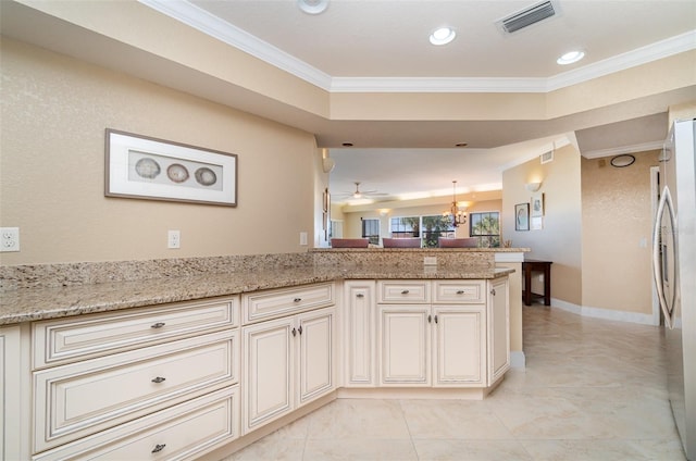 1326 Wesley Dr Unit 123, Punta Gorda, FL 33950 - kitchen with ornamental molding, visible vents, freestanding refrigerator, and cream cabinets