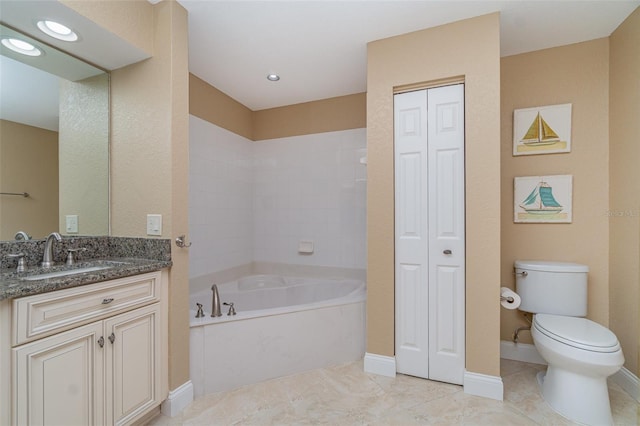 1326 Wesley Dr Unit 123, Punta Gorda, FL 33950 - bathroom featuring a closet, baseboards, toilet, vanity, and a garden tub