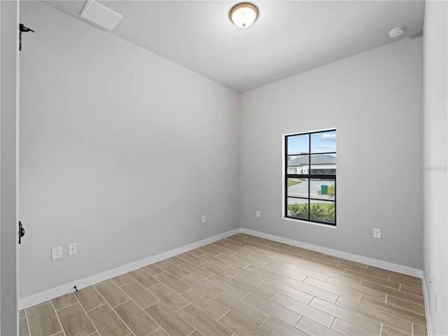 4425 Lagoon Ter, North Port, FL 34286 - spare room with a smoke detector, baseboards, and wood tiled floors