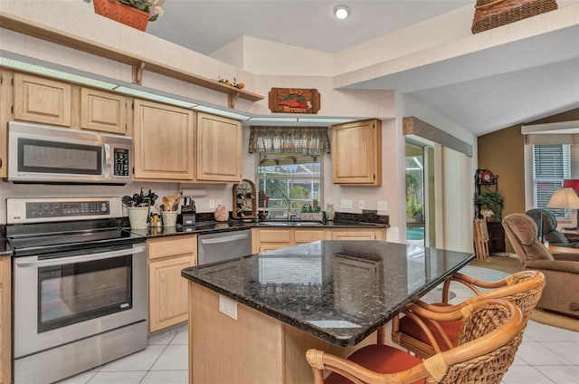 23104 Turnbull Ave, Port Charlotte, FL 33954 - kitchen featuring light tile patterned floors, light brown cabinetry, and appliances with stainless steel finishes