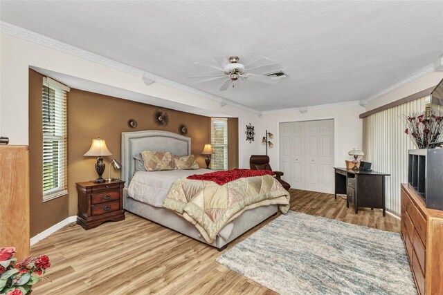 23104 Turnbull Ave, Port Charlotte, FL 33954 - bedroom with visible vents, a closet, baseboards, crown molding, and light wood-style flooring