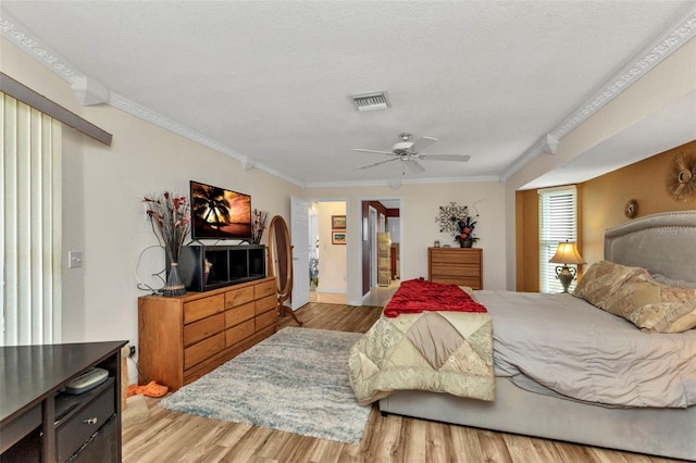 23104 Turnbull Ave, Port Charlotte, FL 33954 - bedroom featuring crown molding, ceiling fan, visible vents, wood finished floors, and baseboards