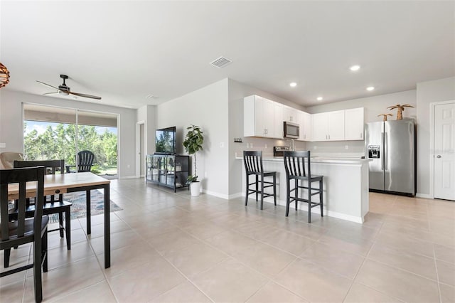 7209 W Lenox Cir, Punta Gorda, FL 33950 - interior space with visible vents, light countertops, ceiling fan, a peninsula, and stainless steel appliances