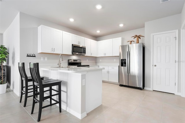 7209 W Lenox Cir, Punta Gorda, FL 33950 - kitchen featuring a sink, light countertops, a peninsula, white cabinetry, and stainless steel appliances