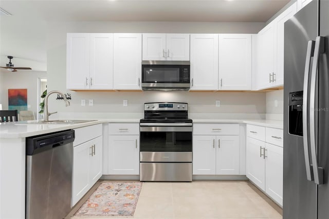 7209 W Lenox Cir, Punta Gorda, FL 33950 - kitchen with a peninsula, light tile patterned floors, light countertops, appliances with stainless steel finishes, and a sink