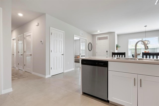7209 W Lenox Cir, Punta Gorda, FL 33950 - kitchen with a sink, light tile patterned floors, stainless steel dishwasher, and white cabinets