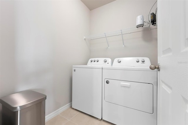 7209 W Lenox Cir, Punta Gorda, FL 33950 - laundry room with baseboards, laundry area, washing machine and clothes dryer, and light tile patterned flooring