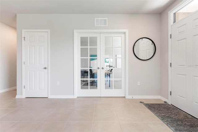 7209 W Lenox Cir, Punta Gorda, FL 33950 - entrance foyer with french doors, visible vents, baseboards, and light tile patterned flooring