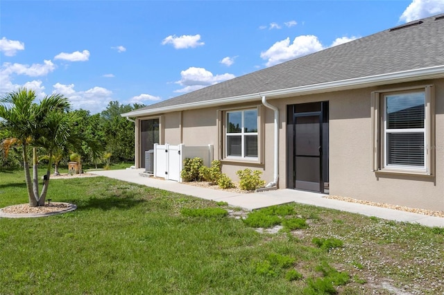 7209 W Lenox Cir, Punta Gorda, FL 33950 - back of house with a yard, stucco siding, and central AC