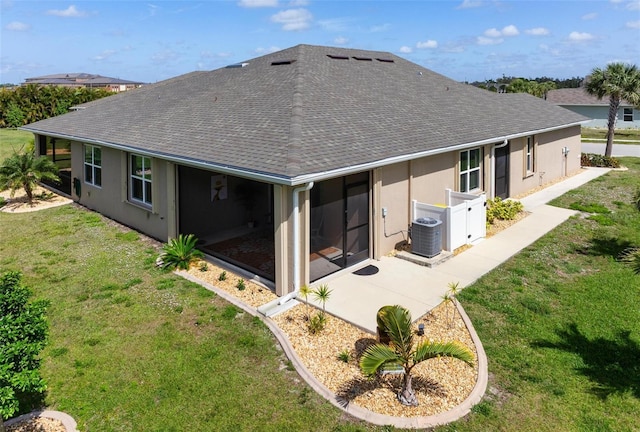 7209 W Lenox Cir, Punta Gorda, FL 33950 - back of house with a lawn, cooling unit, a patio, stucco siding, and roof with shingles