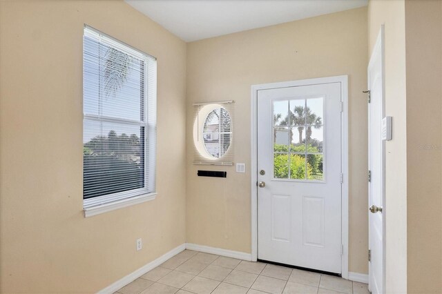 1085 Jonah Dr, North Port, FL 34289 - doorway with light tile patterned flooring and baseboards