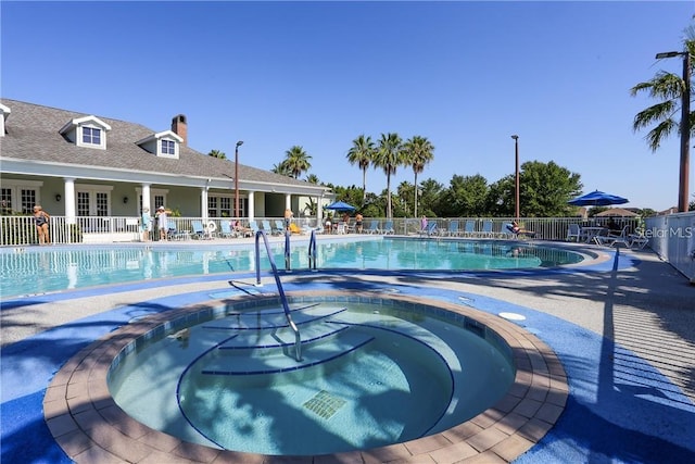 1085 Jonah Dr, North Port, FL 34289 - community pool with a hot tub, fence, and a patio