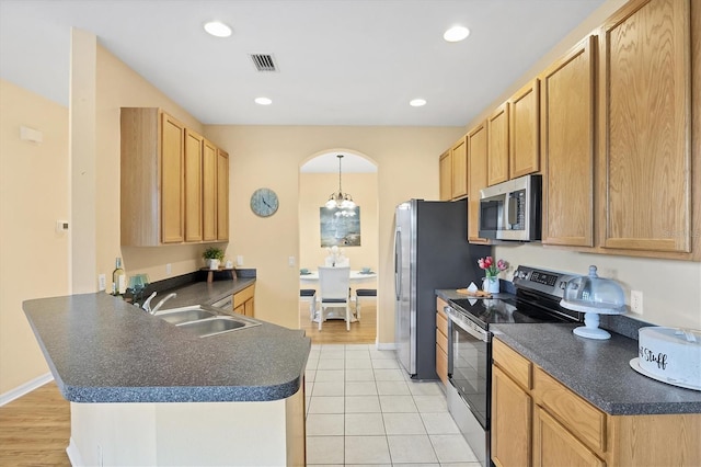 1085 Jonah Dr, North Port, FL 34289 - kitchen featuring stainless steel appliances, a peninsula, dark countertops, light tile patterned flooring, and recessed lighting