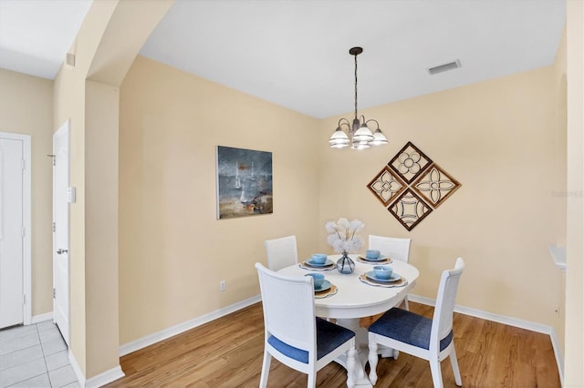 1085 Jonah Dr, North Port, FL 34289 - dining space featuring a chandelier and light wood-type flooring