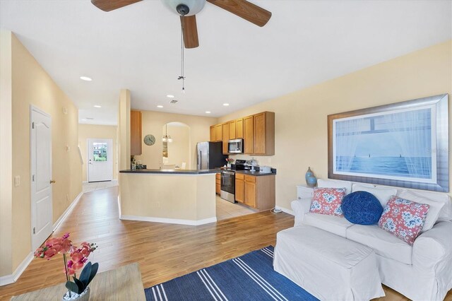 1085 Jonah Dr, North Port, FL 34289 - living area with arched walkways, light wood-type flooring, a ceiling fan, and recessed lighting