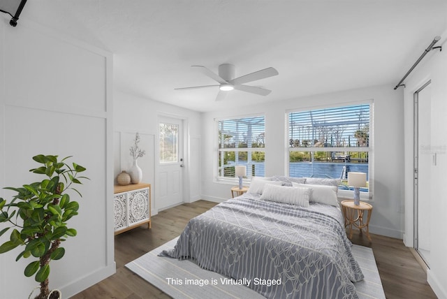 bedroom featuring baseboards, ceiling fan, and wood finished floors