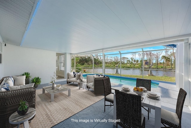 sunroom / solarium featuring an outdoor hangout area, a swimming pool, and a water view