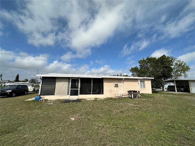 rear view of property with stucco siding and a lawn