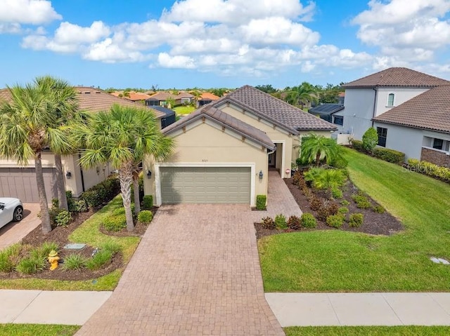 mediterranean / spanish-style home with a garage, stucco siding, decorative driveway, and a front lawn