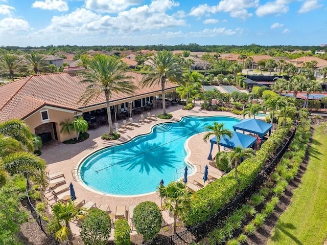pool with a patio and fence