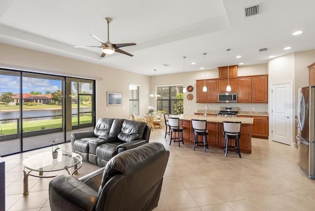 living area with recessed lighting, light tile patterned floors, visible vents, and a ceiling fan