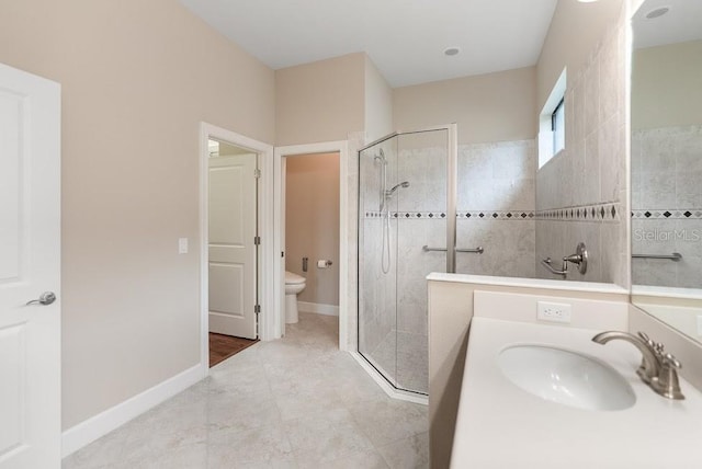 full bath featuring a walk in shower, baseboards, a sink, and toilet