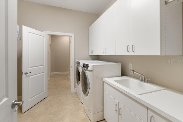 laundry room featuring light tile patterned floors, separate washer and dryer, a sink, and cabinet space